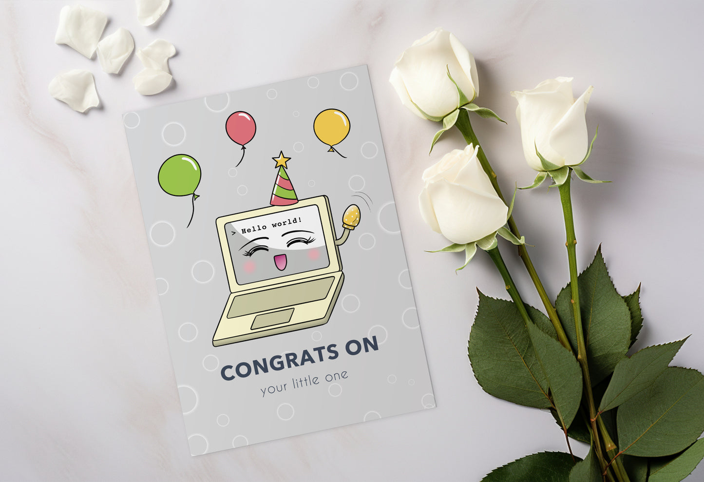 A kawaii greeting card from Rainbow & Bubbles, showing a laptop displaying Hello world! Baby Laptop is celebrating the birth of a baby. The front says "Congrats on your little one".