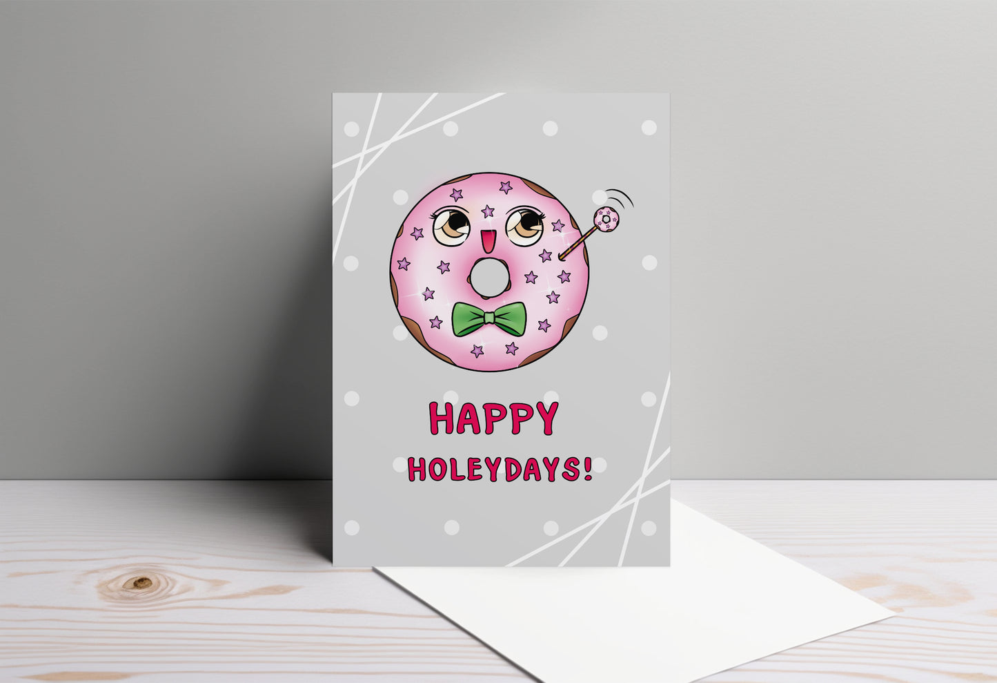 A kawaii greeting card from Rainbow & Bubbles, showing a kawaii glazed donut with a fancy bowtie saying Happy Holeydays!