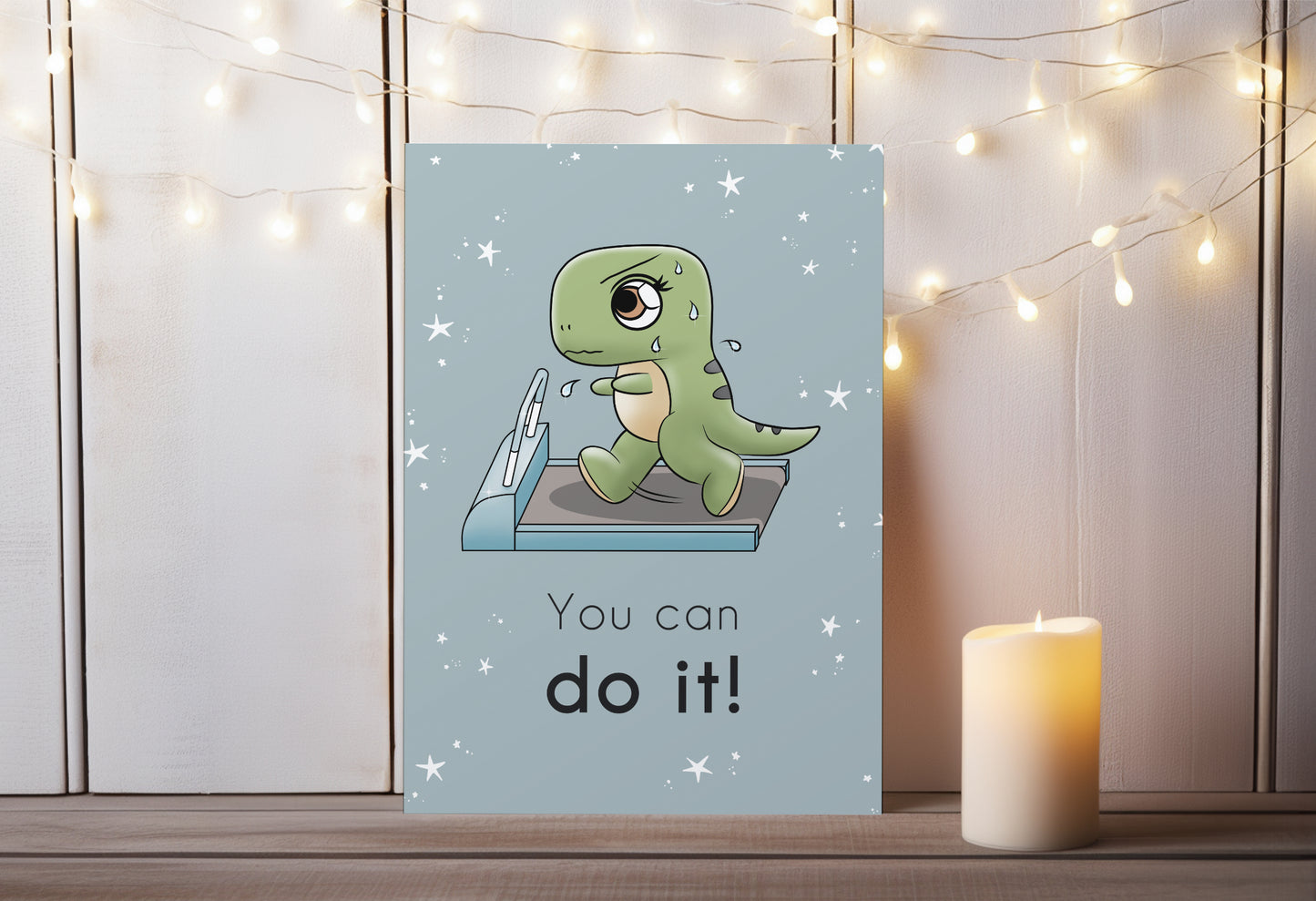 A kawaii greeting card from Rainbow & Bubbles, showing a t-rex running and sweating on the treadmill. The front says "You can do it!"