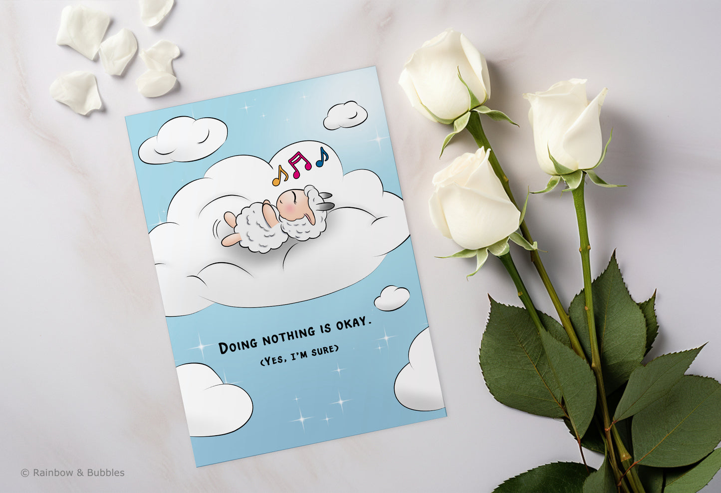A kawaii greeting card from Rainbow & Bubbles, showing a sheep doing nothing, simply relaxing in a bed of cloud and humming his favorite tune.