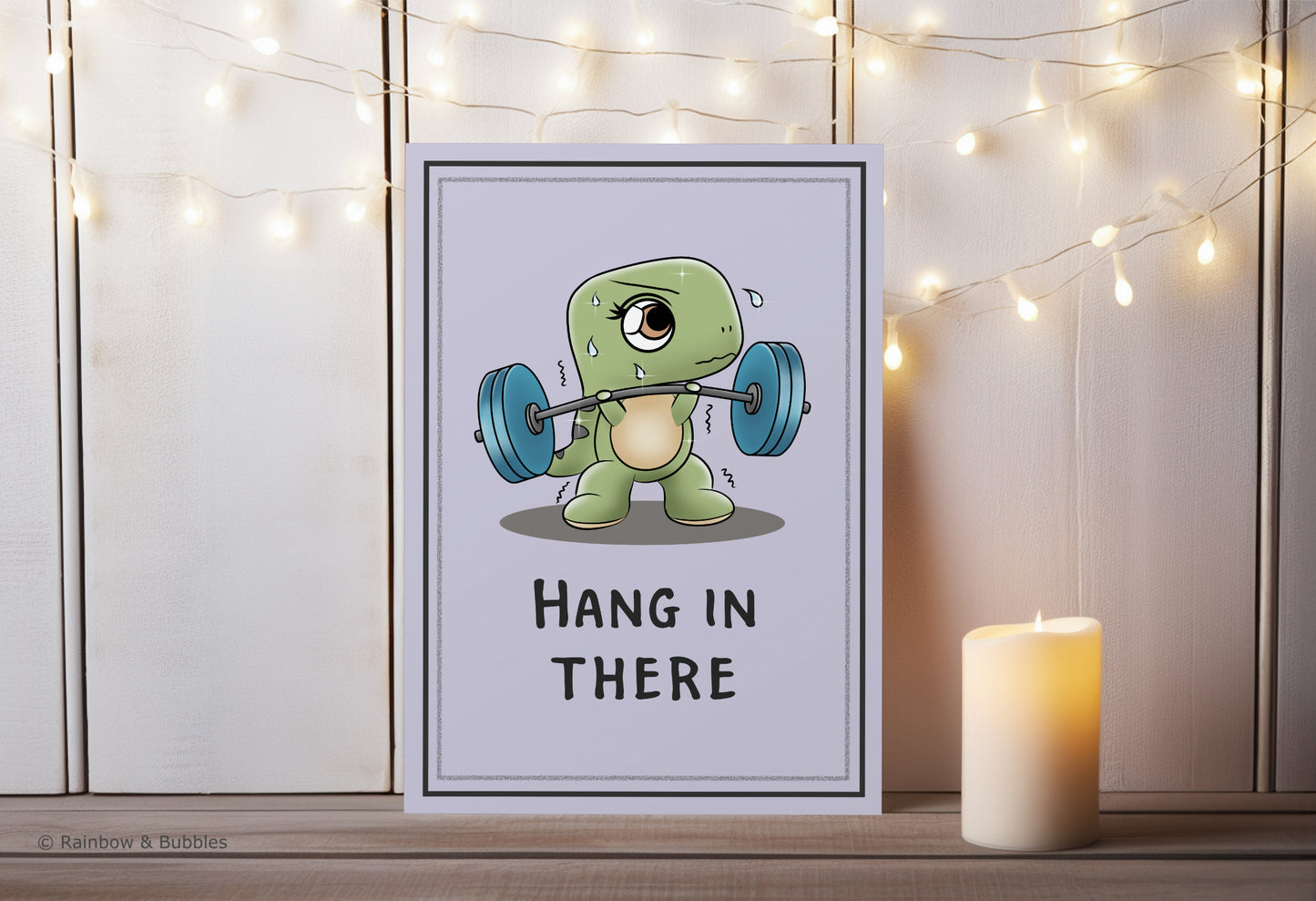 A kawaii greeting card from Rainbow & Bubbles, showing a t-rex struggling to lift weights with his tiny arms.