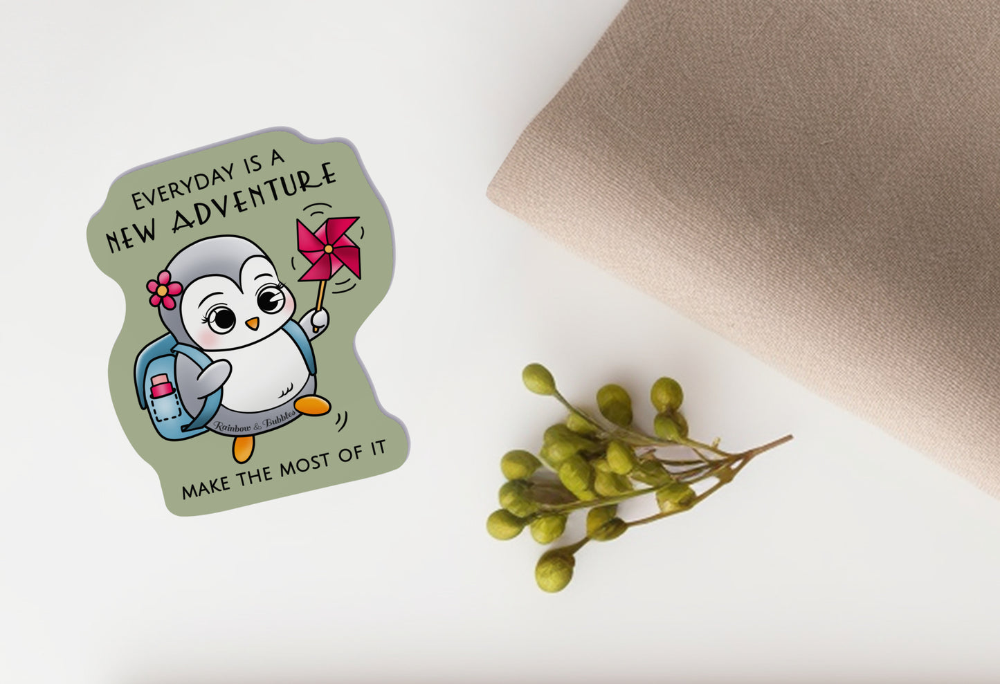 Little Penguin going on an adventure called "today", with a water bottle, a nice flower hair clip, and a pinwheel for fun. Kawaii vinyl sticker from Rainbow & Bubbles, with "everyday is a new adventure, make the most of it" text.