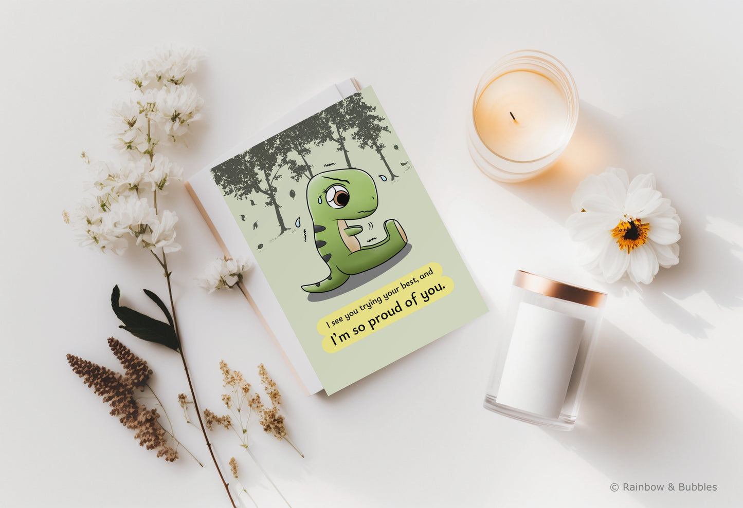 A kawaii greeting card from Rainbow & Bubbles, showing a t-rex stretching and struggling to touch his toes with his little arms.