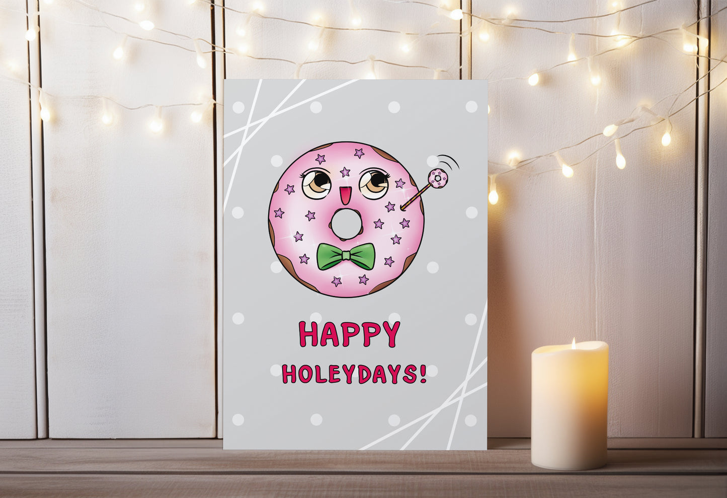 A kawaii greeting card from Rainbow & Bubbles, showing a kawaii glazed donut with a fancy bowtie saying Happy Holeydays!