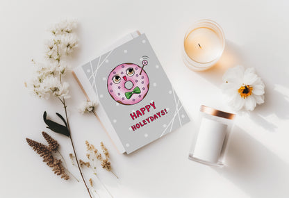 A kawaii greeting card from Rainbow & Bubbles, showing a kawaii glazed donut with a fancy bowtie saying Happy Holeydays!