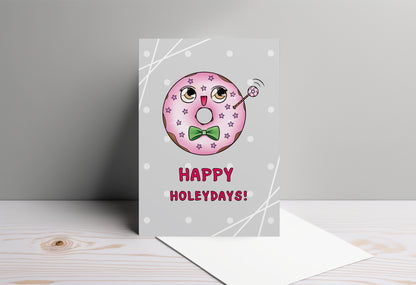 A kawaii greeting card from Rainbow & Bubbles, showing a kawaii glazed donut with a fancy bowtie saying Happy Holeydays!