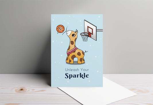 A kawaii greeting card from Rainbow & Bubbles, showing Baby Giraffe in her element as the Star Defender at basketball. The front says "Unleash your sparkle".