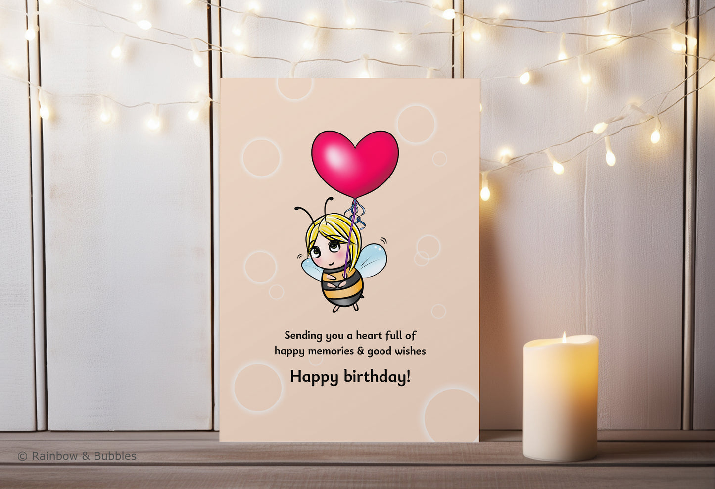 A kawaii birthday card from Rainbow & Bubbles, showing a bee holding a heart balloon.