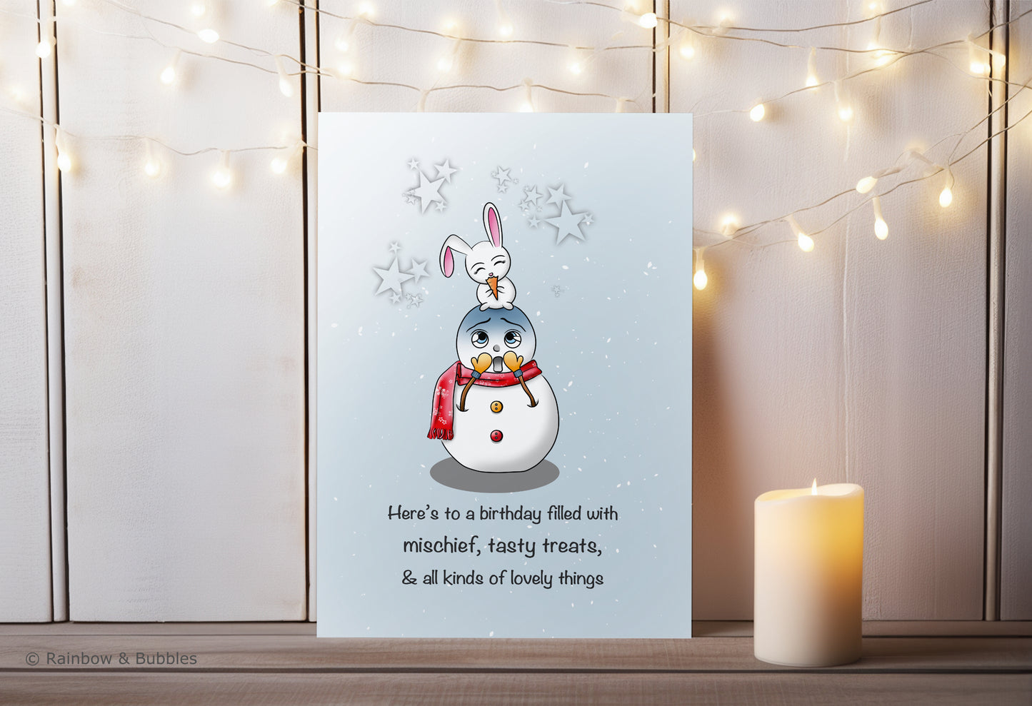 A kawaii birthday card from Rainbow & Bubbles, showing a mischievous bunny eating a tasty treat (the snowman's nose).
