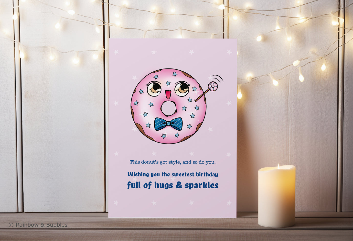 A kawaii birthday card from Rainbow & Bubbles, showing a kawaii glazed donut with a fancy bowtie waving at you.