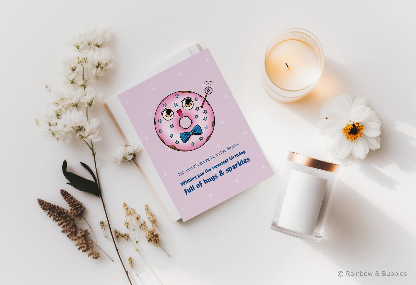 A kawaii birthday card from Rainbow & Bubbles, showing a kawaii glazed donut with a fancy bowtie waving at you.