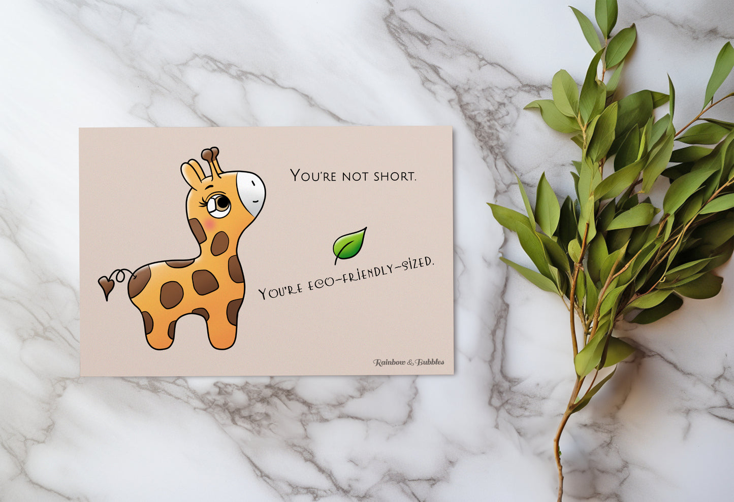 A kawaii postcard from Rainbow & Bubbles, showing a baby giraffe who's looking very pleased.