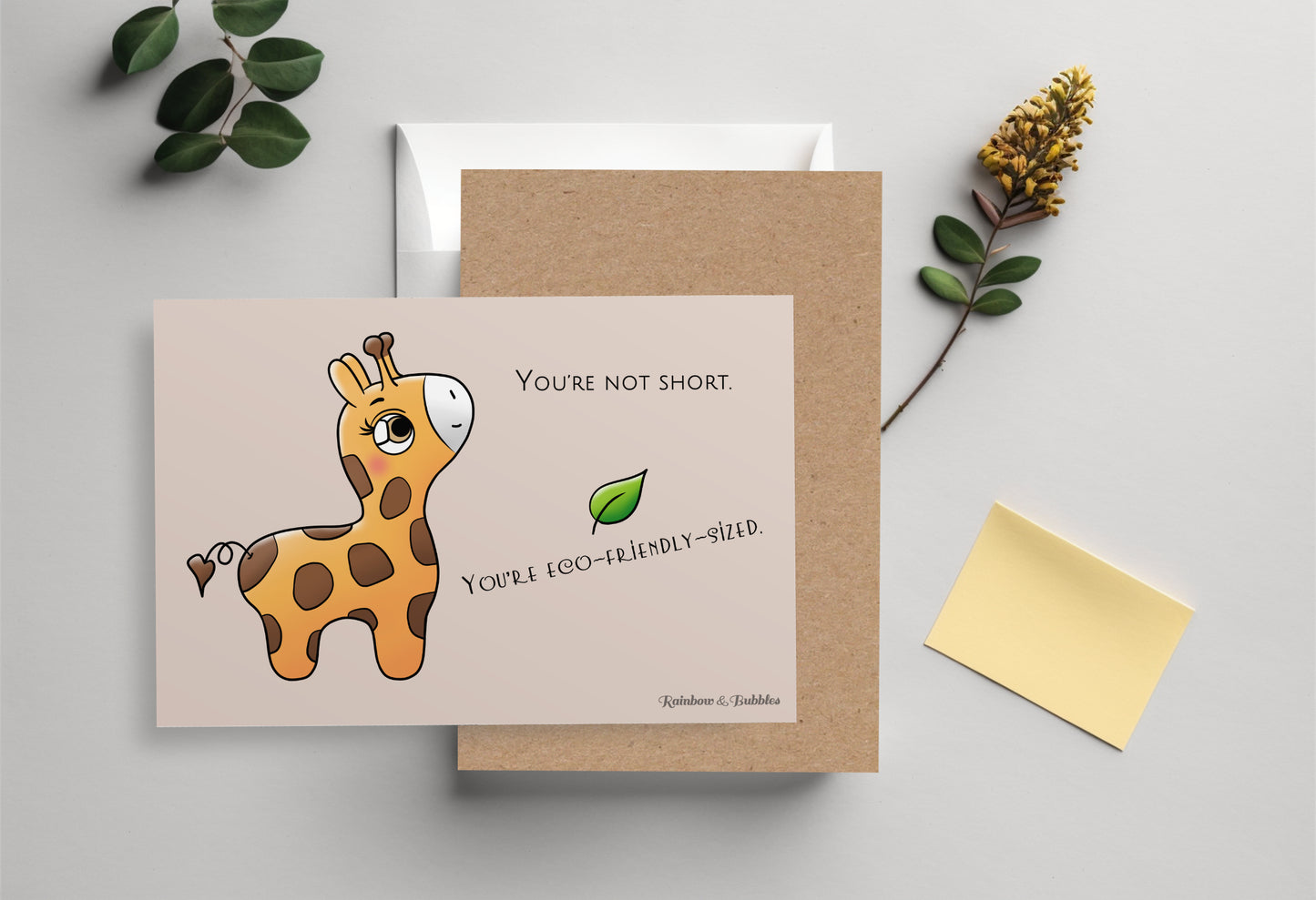 A kawaii postcard from Rainbow & Bubbles, showing a baby giraffe who's looking very pleased.