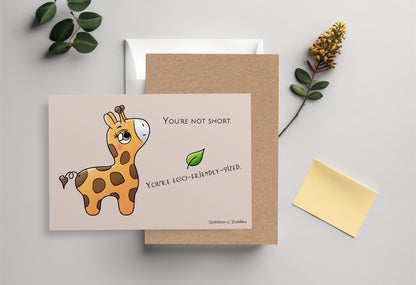 A kawaii postcard from Rainbow & Bubbles, showing a baby giraffe who's looking very pleased.