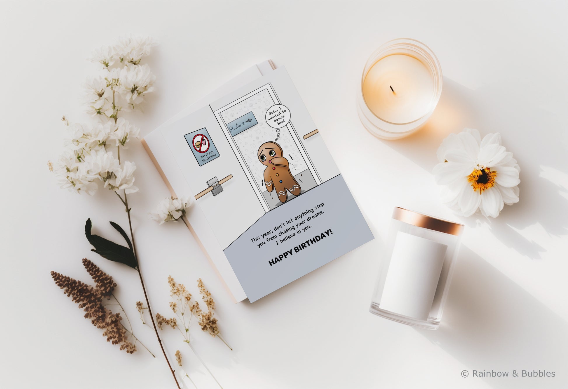 A kawaii birthday card from Rainbow & Bubbles, showing a gingerbread man who is facing an obstacle in his journey towards his dreams.