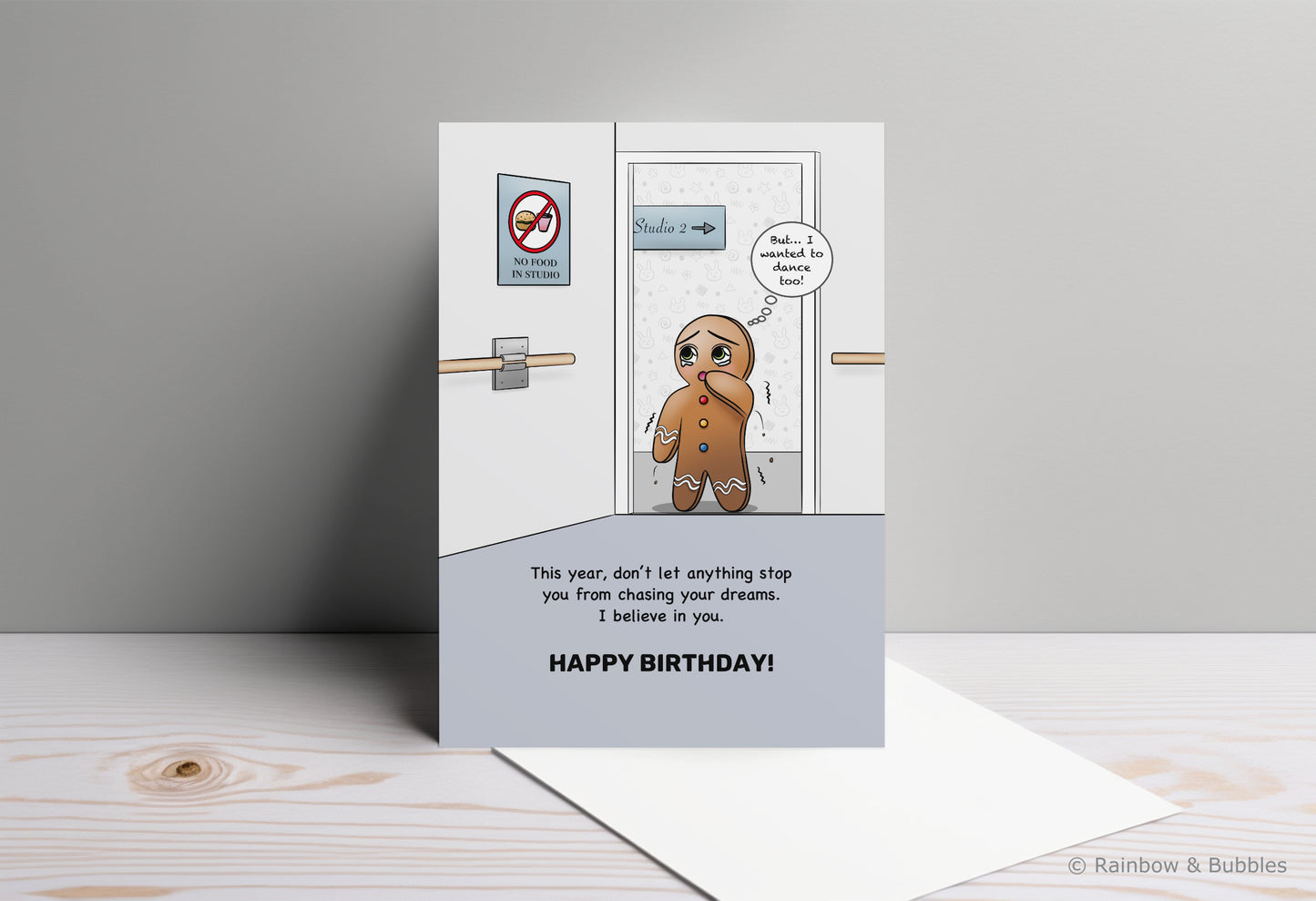 A kawaii birthday card from Rainbow & Bubbles, showing a gingerbread man who is facing an obstacle in his journey towards his dreams.