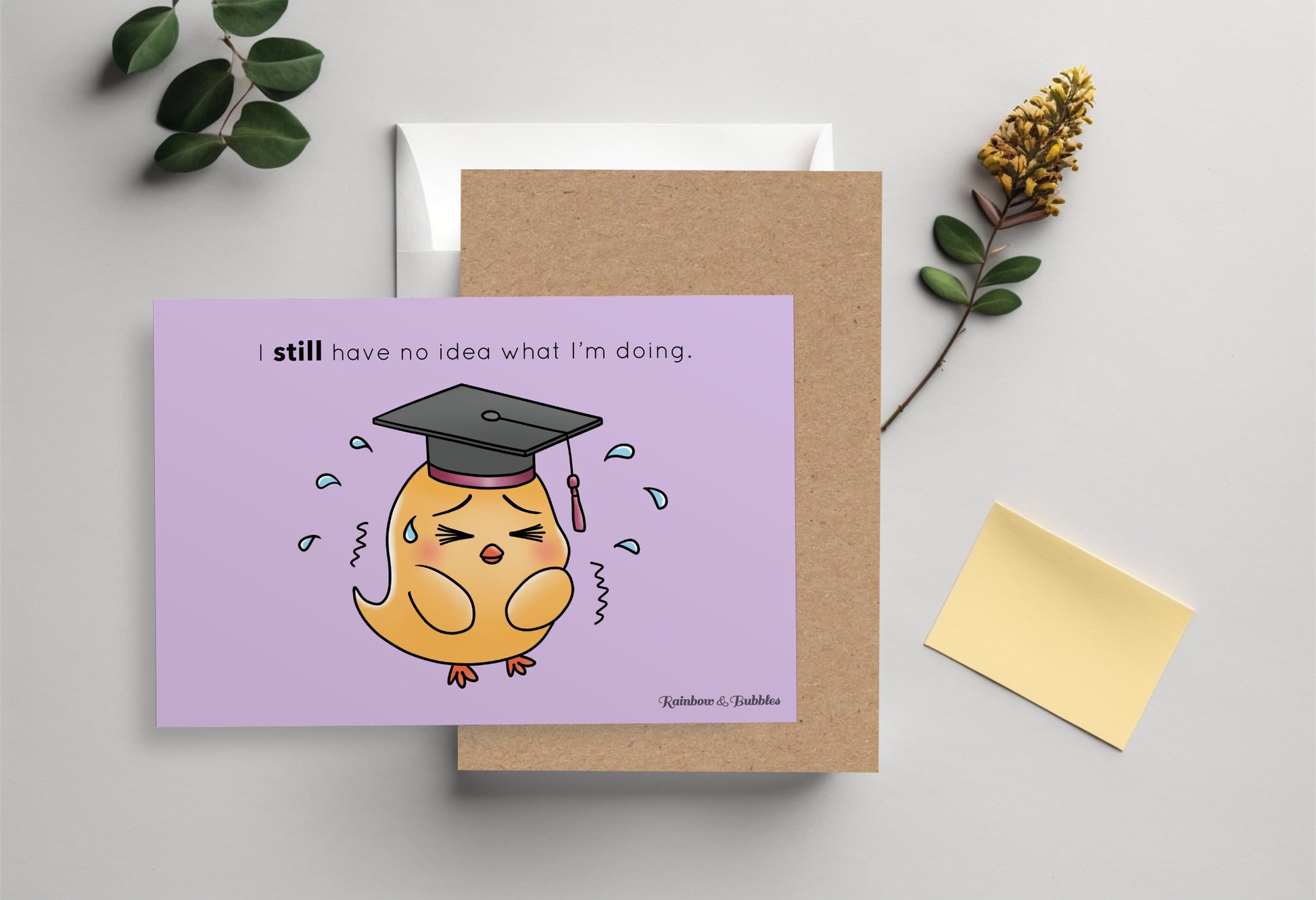 A kawaii postcard from Rainbow & Bubbles, showing a baby chick with a graduation hat who's sweating profusely out of anxiety.
