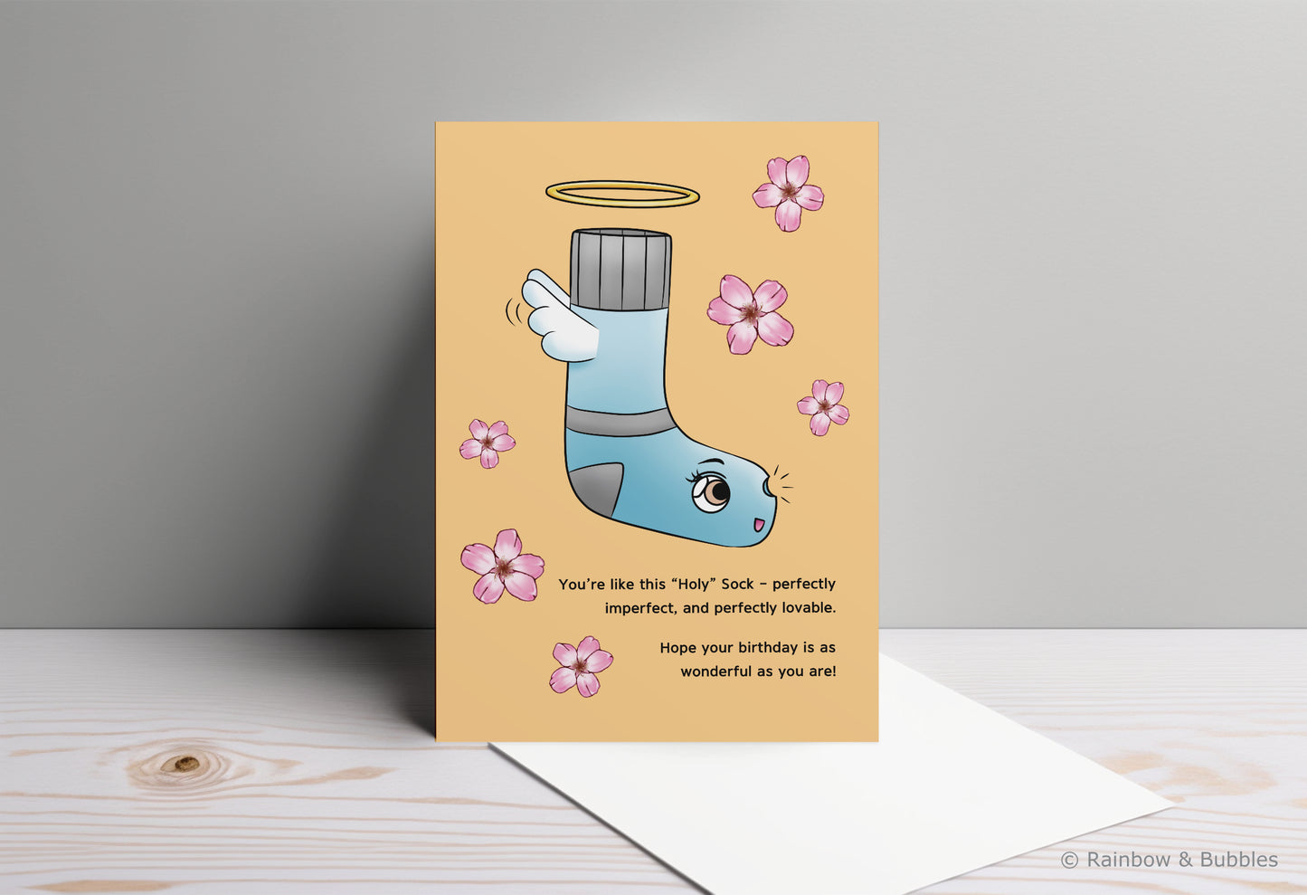 A kawaii birthday card from Rainbow & Bubbles, showing a Holy Sock who's perfectly imperfect and perfectly lovable.