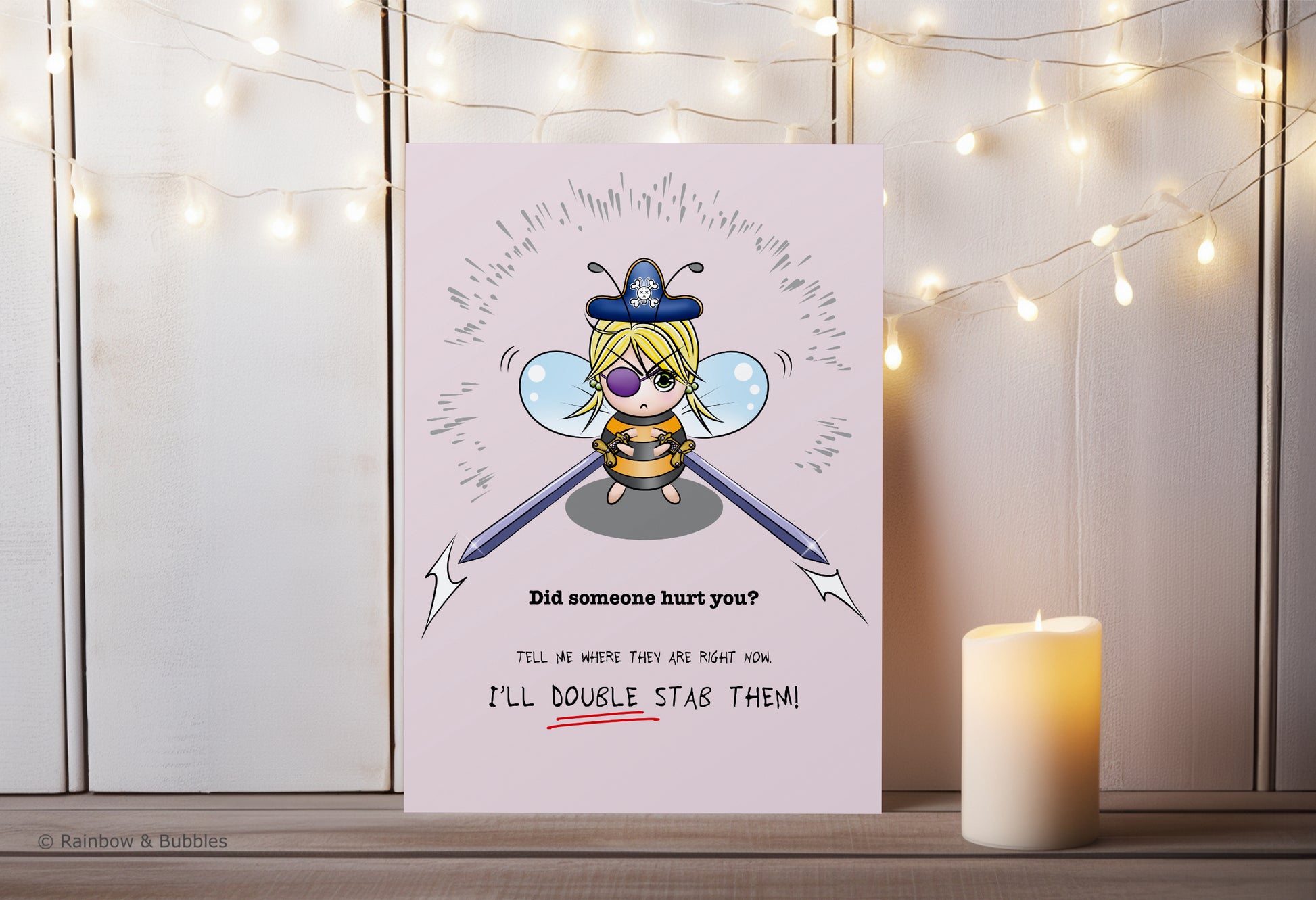 A kawaii greeting card from Rainbow & Bubbles, showing a pirate bee with massive swords.
